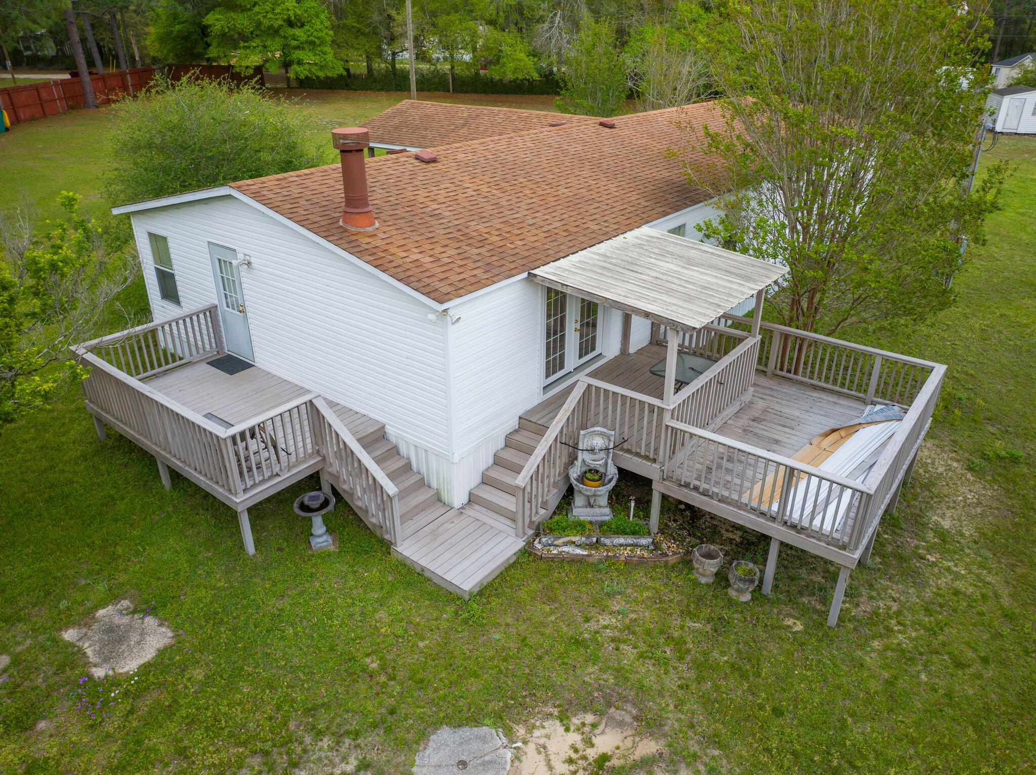 3062 Highland Avenue Crestview, FL 32539 - Photo 42 of 58 aerial view of a house with a yard table and chairs