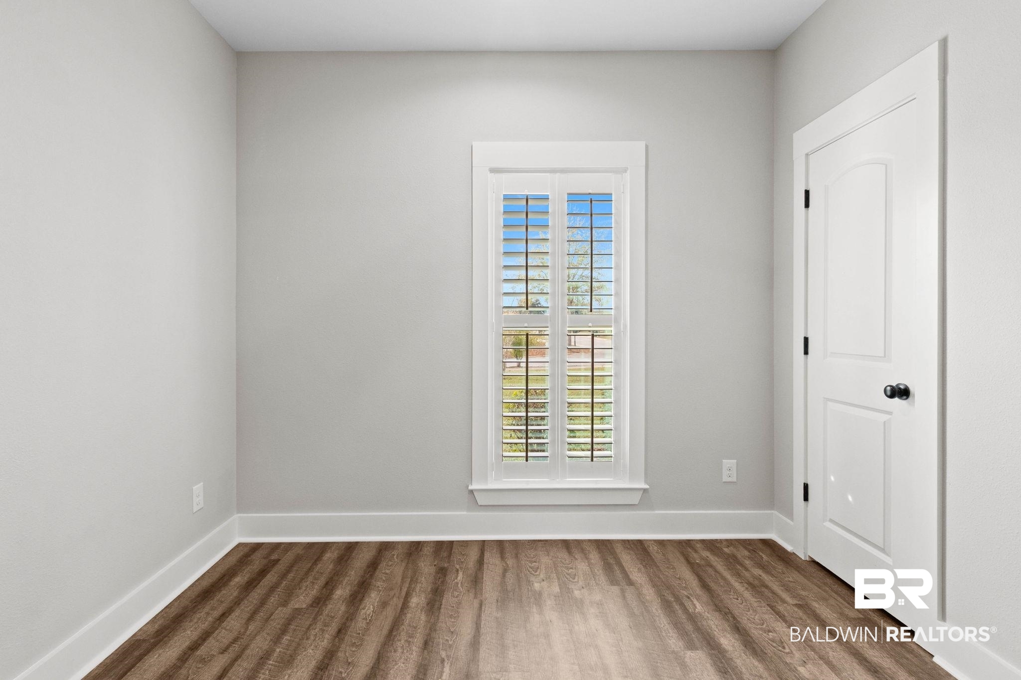 17376 Bankhead Boulevard Fairhope, AL 36532 - Photo 46 of 73 Empty room with dark wood-type flooring and baseboards