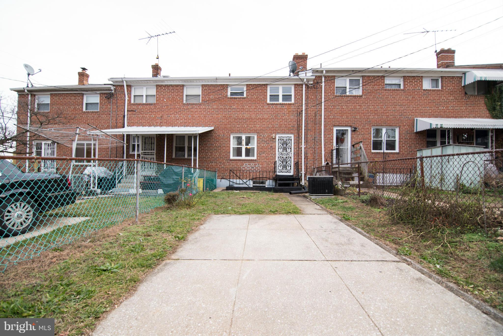 604 Queensgate Road Baltimore, MD 21229 - Photo 22 of 22 a front view of a house with garden