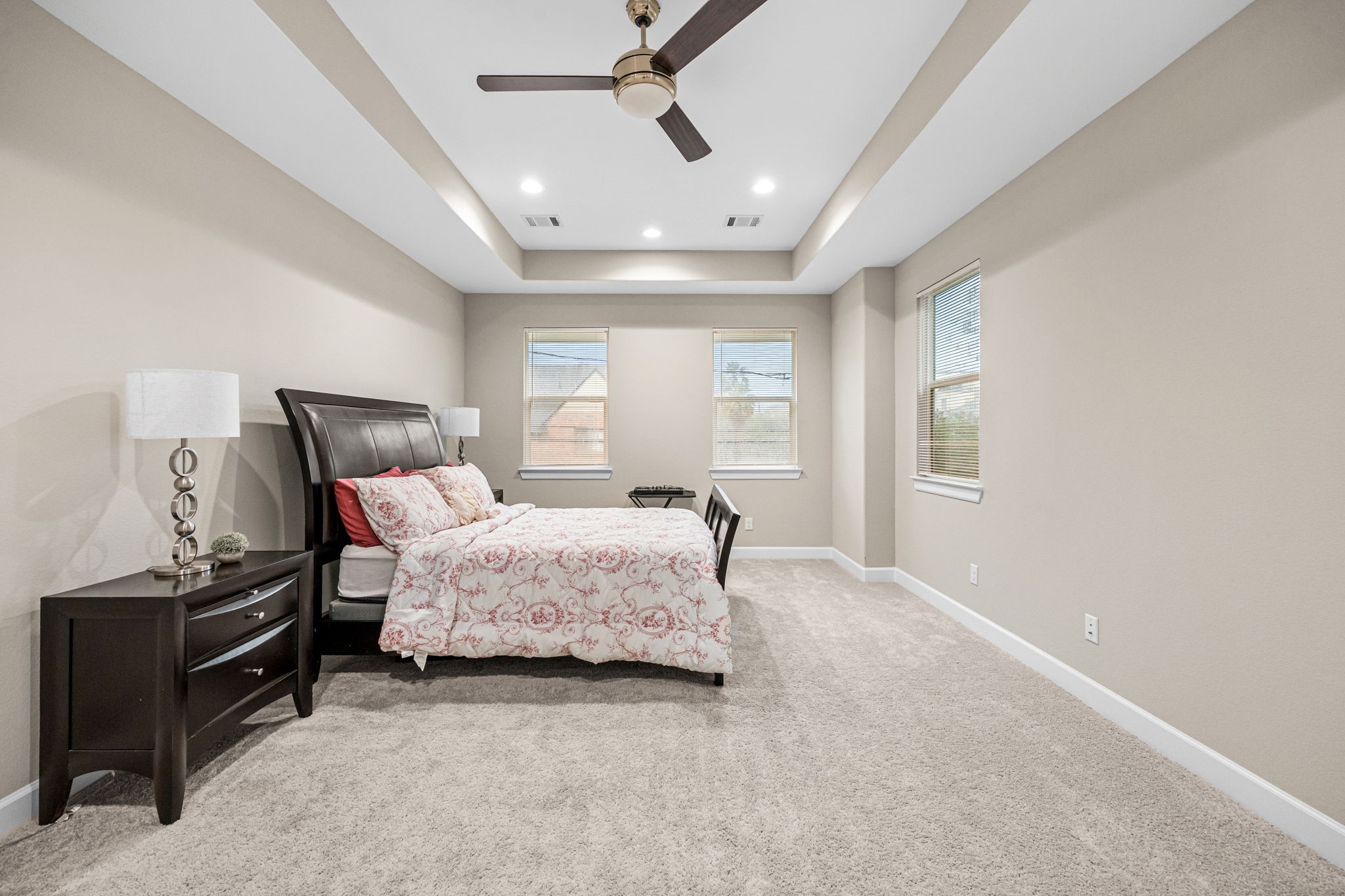 1732 Wichita Street Houston, TX 77004 - Photo 15 of 35 Large primary bedroom filled with natural light and featuring elevated ceilings, neutral tones, and a spacious layout. Located on the 2nd floor with a tray ceiling.