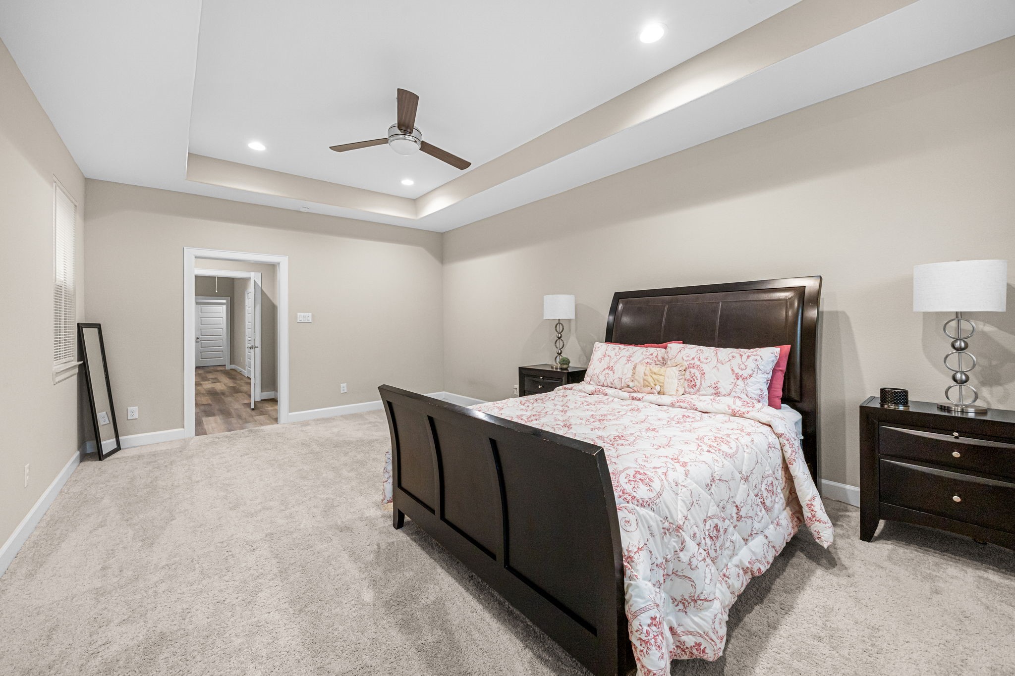 1732 Wichita Street Houston, TX 77004 - Photo 16 of 35 Expansive primary suite with tray ceilings, recessed lighting, plush carpeting, and ample room for oversized furniture.