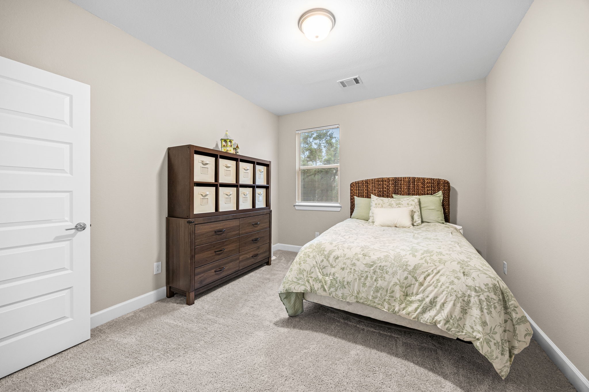 1732 Wichita Street Houston, TX 77004 - Photo 25 of 35 Secondary bedroom with plush carpeting, neutral tones, and abundant natural light.