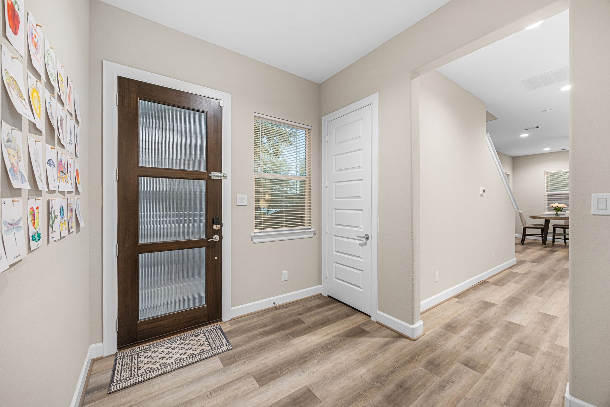 1732 Wichita Street Houston, TX 77004 - Photo 3 of 35 Welcoming entryway featuring contemporary front door design, high ceilings, and durable wood-look flooring.