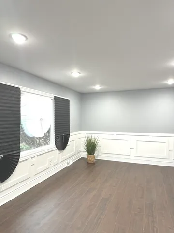 a view of wooden floor and windows in a room