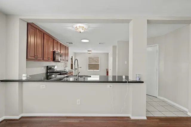 a kitchen with granite countertop a sink and cabinets