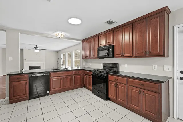 a kitchen with stainless steel appliances granite countertop a stove sink and cabinets