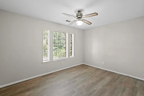 a view of a room with wooden floor and windows