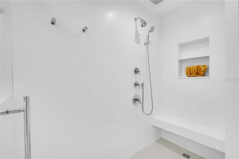 a bathroom with a shower and a glass door