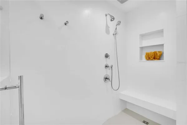 a bathroom with a shower and a glass door