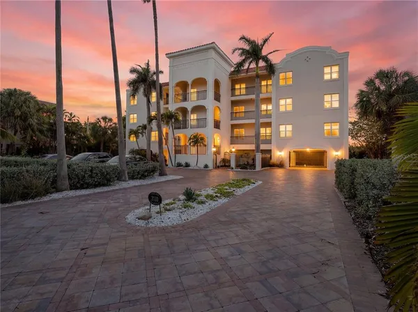 a front view of a residential apartment building with a yard
