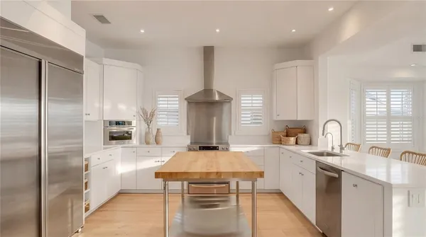 a dining room with furniture and a potted plant
