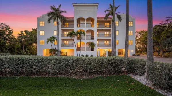 a living room with patio furniture and floor to ceiling windows