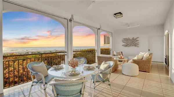 a living room with furniture fireplace and a large window