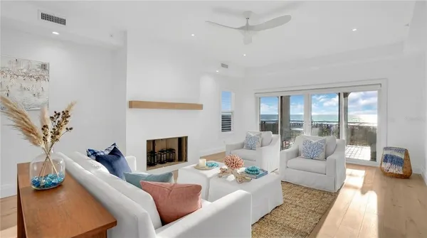 a living room with fireplace furniture and a large window
