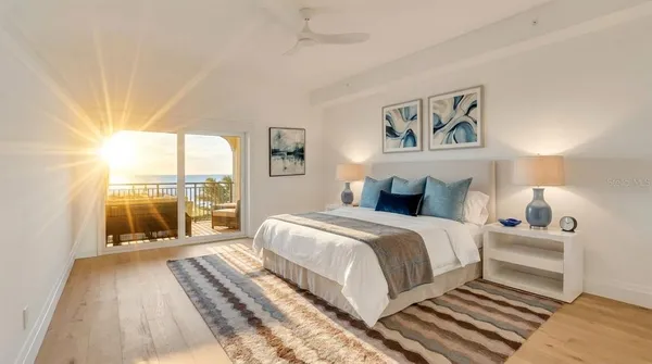 a bedroom with a large bed and a large window