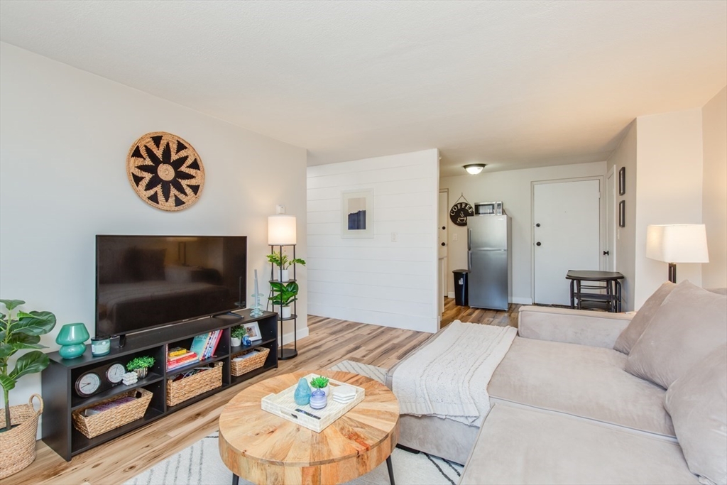 15 Staples Avenue, Unit 46 Everett, MA 02149 - Photo 15 of 35 a living room with furniture and a flat screen tv
