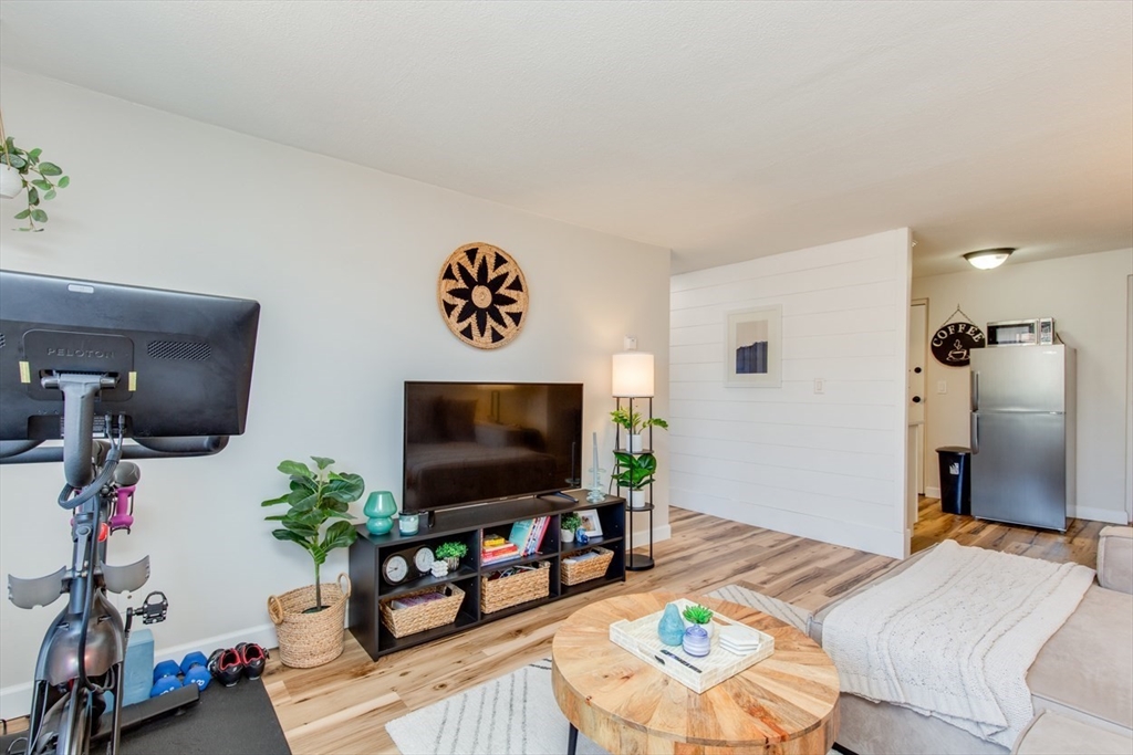 15 Staples Avenue, Unit 46 Everett, MA 02149 - Photo 16 of 35 a living room with furniture and a flat screen tv