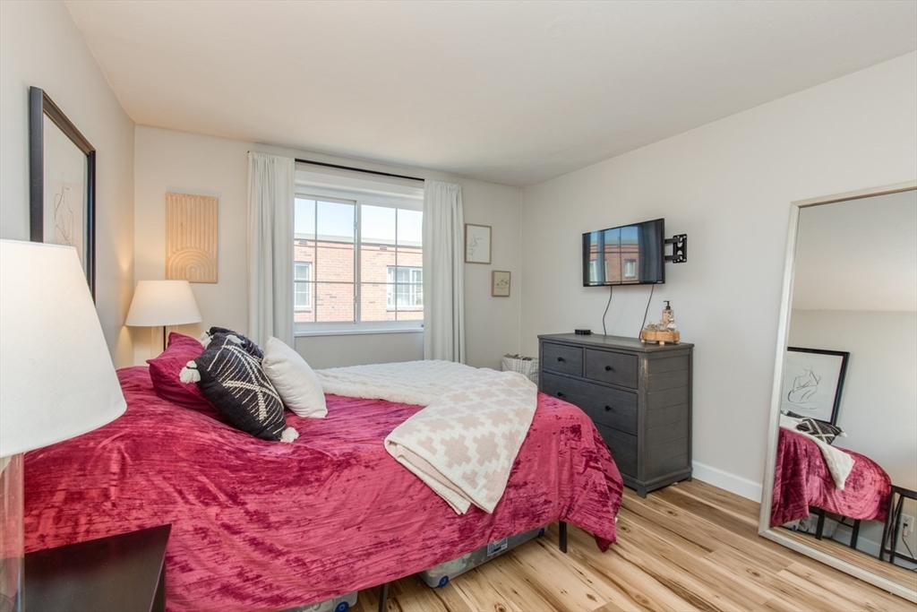 15 Staples Avenue, Unit 46 Everett, MA 02149 - Photo 18 of 35 a bedroom with a bed and wooden floor