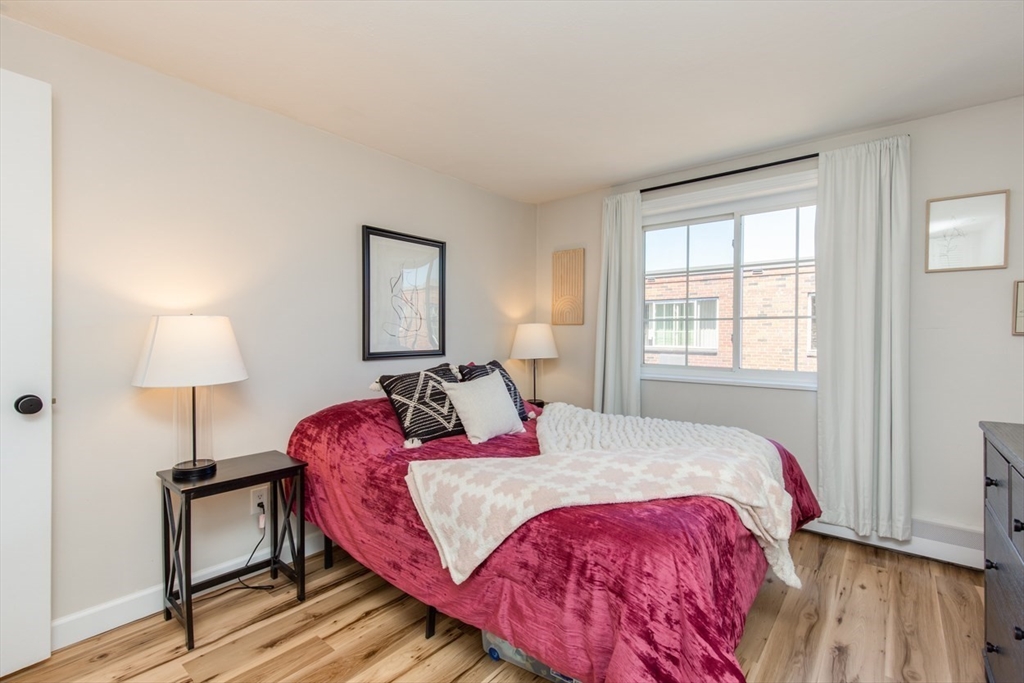 15 Staples Avenue, Unit 46 Everett, MA 02149 - Photo 19 of 35 a bedroom with a bed and a lamp