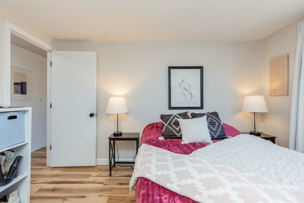 15 Staples Avenue, Unit 46 Everett, MA 02149 - Photo 20 of 35 a bedroom with a bed and a lamp on dresser