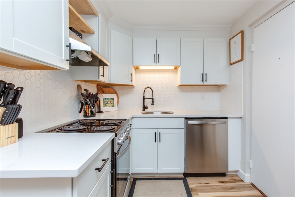 15 Staples Avenue, Unit 46 Everett, MA 02149 - Photo 2 of 35 a kitchen with stainless steel appliances a sink a stove and a refrigerator