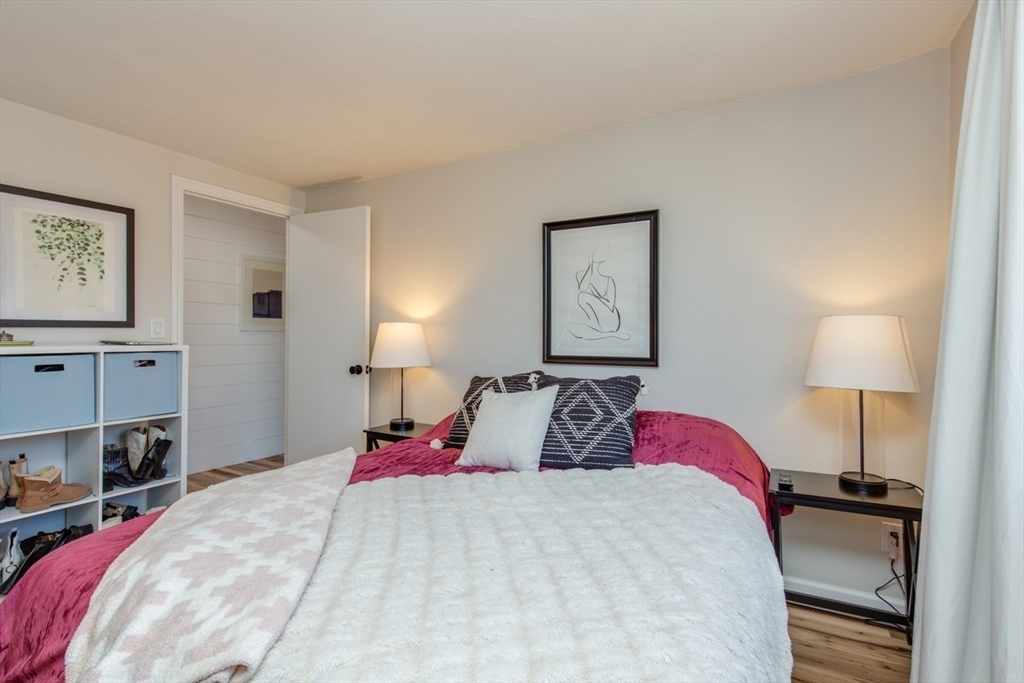 15 Staples Avenue, Unit 46 Everett, MA 02149 - Photo 22 of 35 a bedroom with a bed and wooden floor
