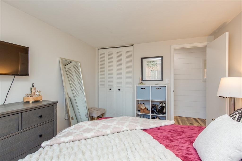 15 Staples Avenue, Unit 46 Everett, MA 02149 - Photo 23 of 35 a bedroom with a bed and a flat screen tv