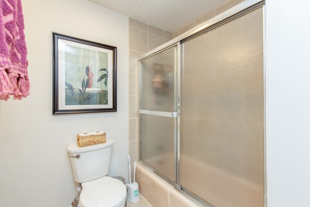 15 Staples Avenue, Unit 46 Everett, MA 02149 - Photo 24 of 35 a white toilet sitting next to a bath tub shower