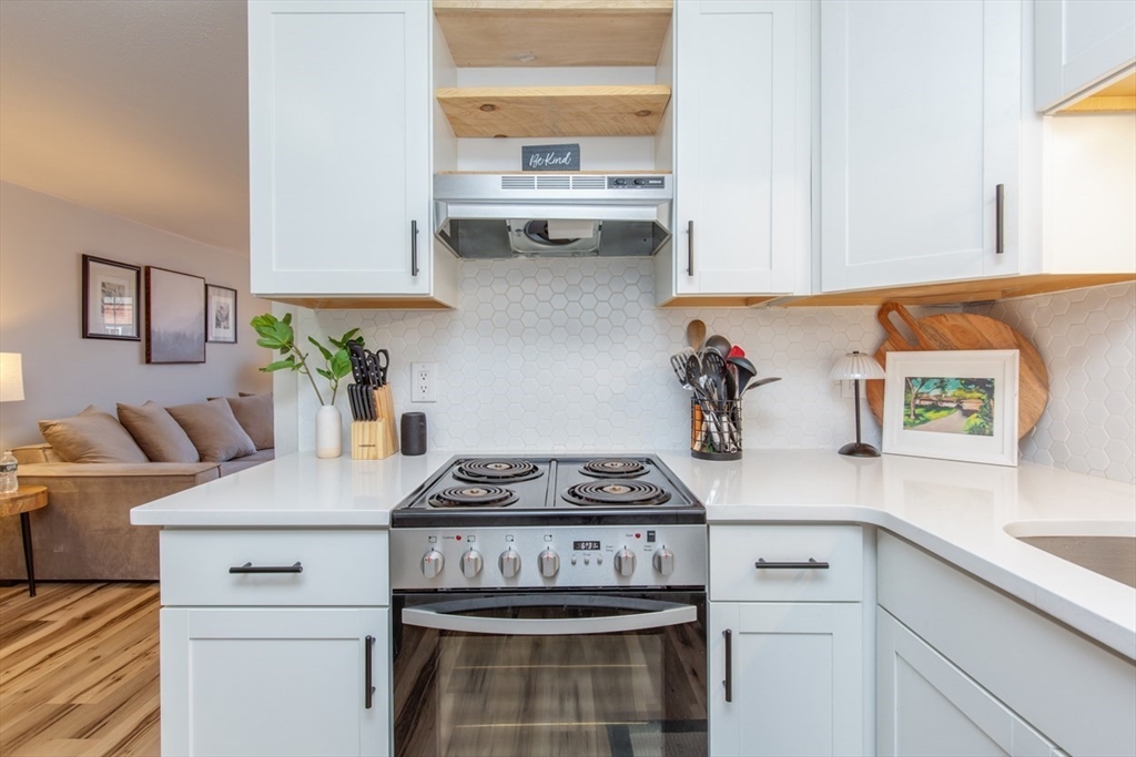 15 Staples Avenue, Unit 46 Everett, MA 02149 - Photo 4 of 35 a kitchen with stainless steel appliances granite countertop a sink a stove and cabinets