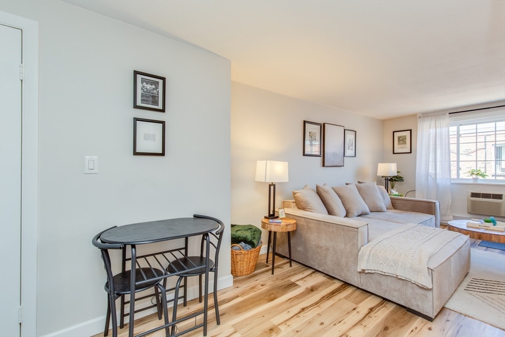 15 Staples Avenue, Unit 46 Everett, MA 02149 - Photo 6 of 35 a living room with a bed and a table