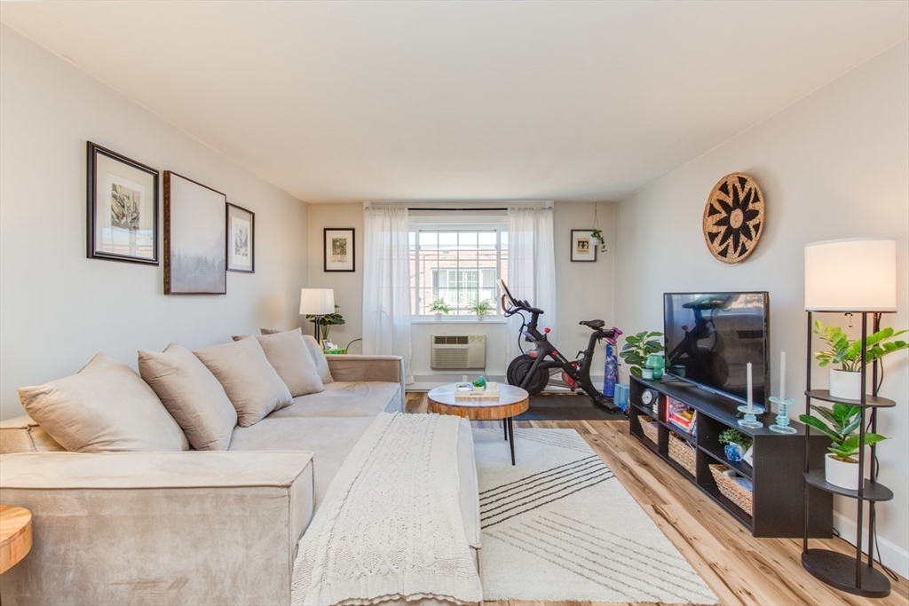 15 Staples Avenue, Unit 46 Everett, MA 02149 - Photo 7 of 35 a living room with furniture and a flat screen tv