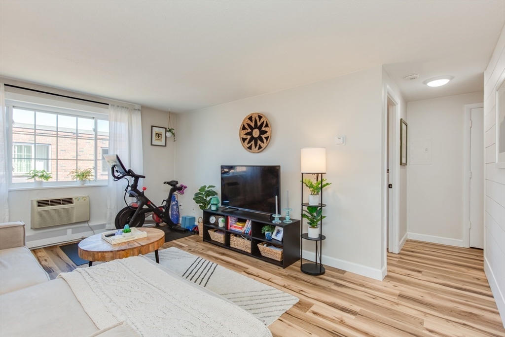 15 Staples Avenue, Unit 46 Everett, MA 02149 - Photo 8 of 35 a living room with furniture and a flat screen tv