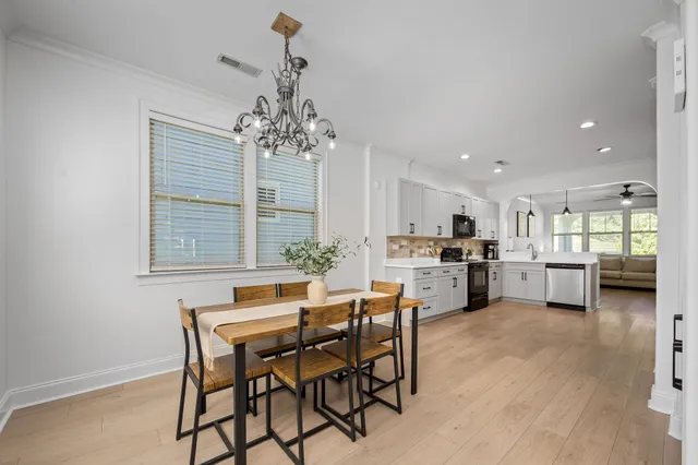 a view of a dining room with furniture and window