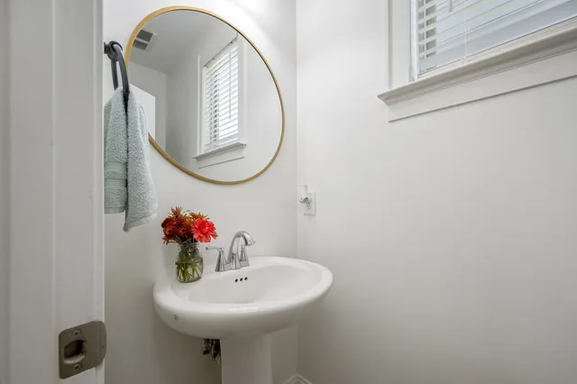 a bathroom with a sink and mirror