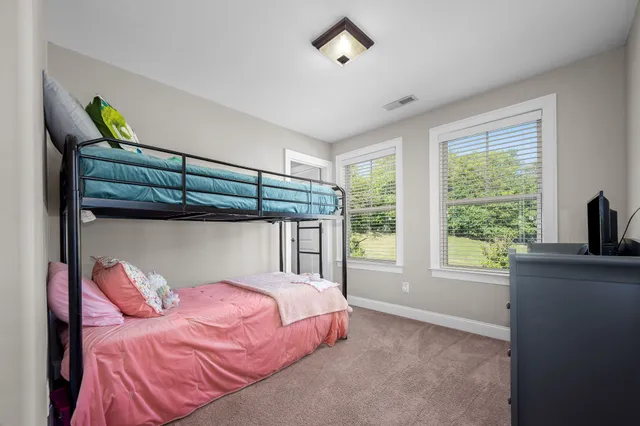 a bedroom with a bed and a desk