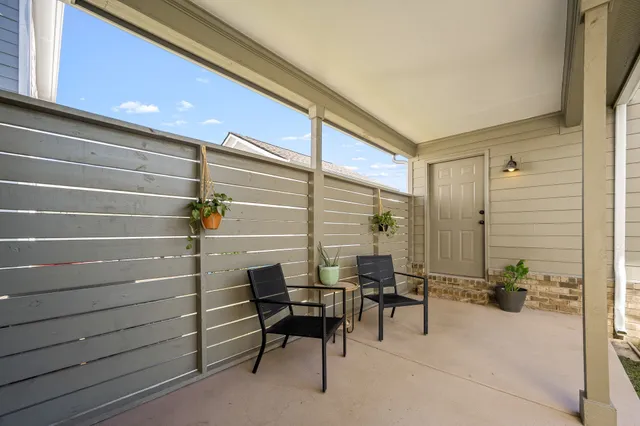 a backyard of a house with yard and outdoor seating