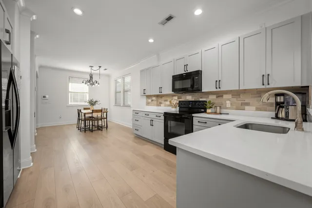 a kitchen with a sink a microwave and cabinets