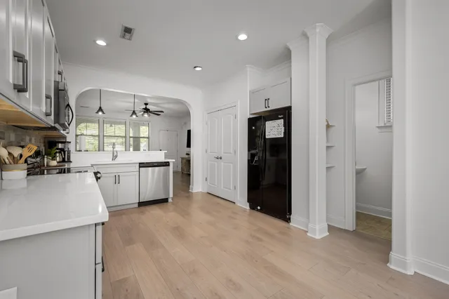 a view of a kitchen with a sink a refrigerator and window