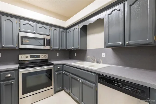 a kitchen with a sink stove and microwave