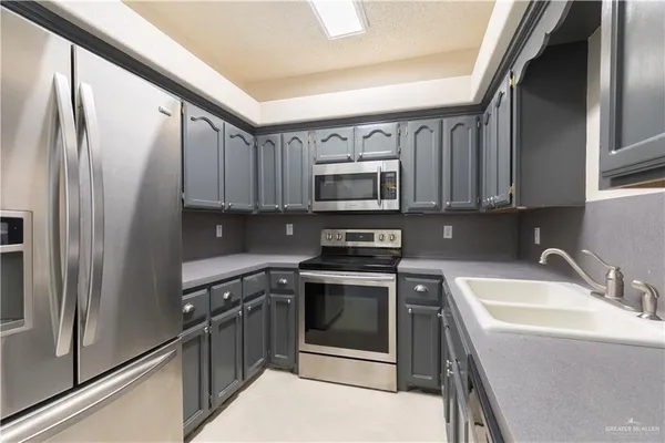 a kitchen with a sink stove and refrigerator