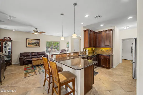 a kitchen with stainless steel appliances granite countertop a stove a sink and a refrigerator