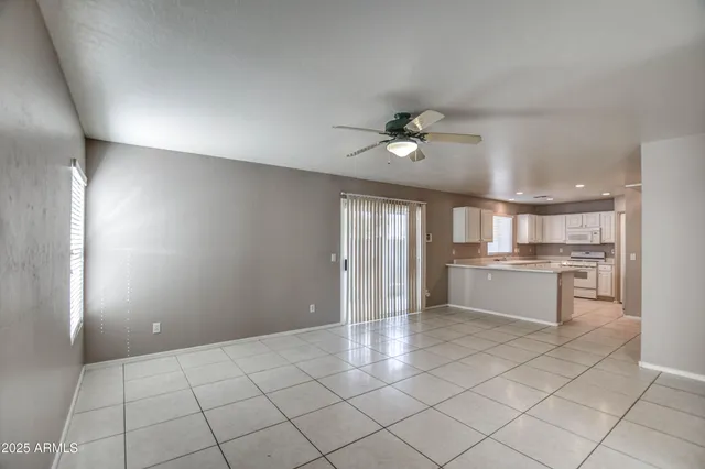 a view of a kitchen with a sink and dishwasher a refrigerator with white cabinets