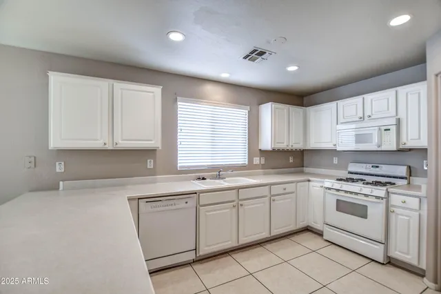 a kitchen that has a sink and a stove in it