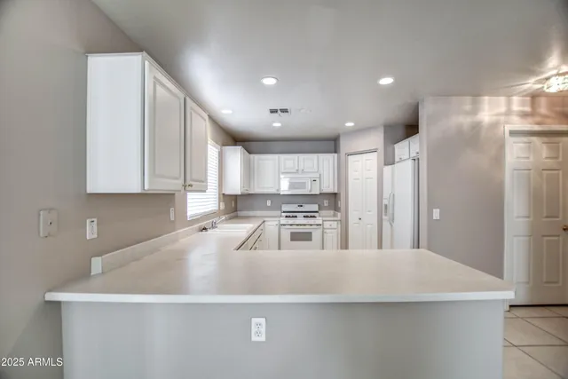 a kitchen with stainless steel appliances a refrigerator sink and cabinets