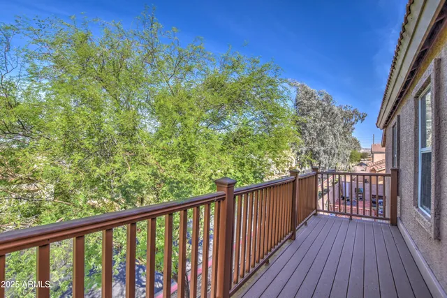 a view of a balcony with wooden floor
