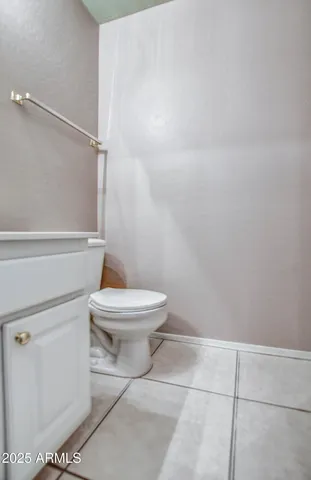a white toilet sitting next to a bath tub