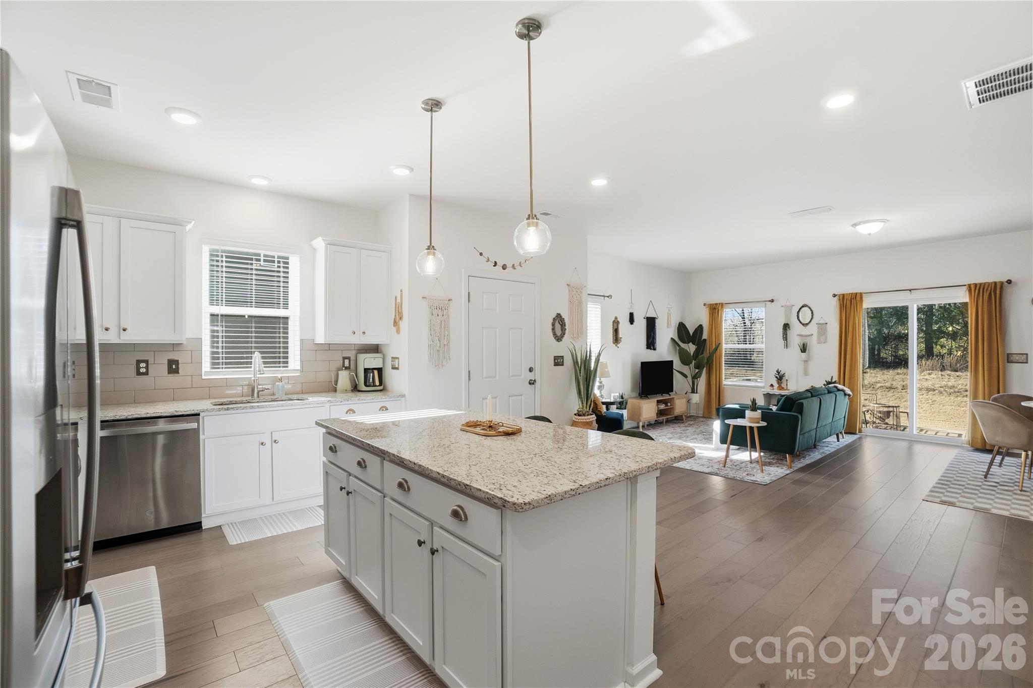 3627 Secrest Landing Monroe, NC 28110 - Photo 11 of 32 a open kitchen with a sink stove and wooden floor