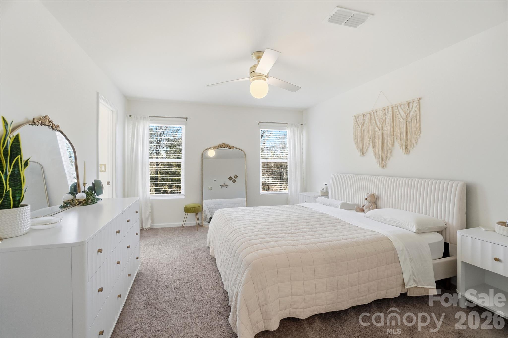 3627 Secrest Landing Monroe, NC 28110 - Photo 19 of 32 a bedroom with a large bed and a chandelier