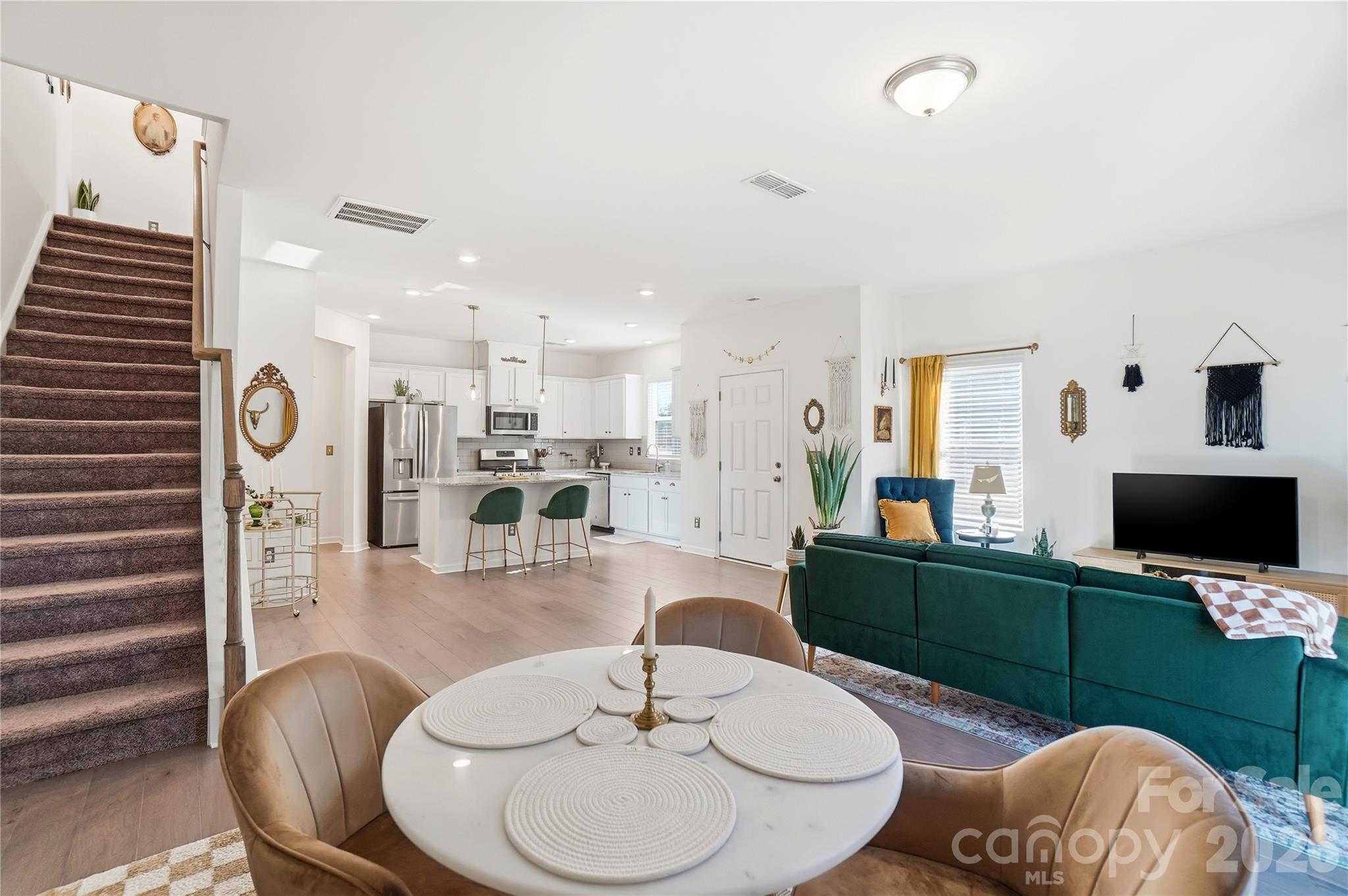 3627 Secrest Landing Monroe, NC 28110 - Photo 9 of 32 a living room with furniture a flat screen tv and kitchen view