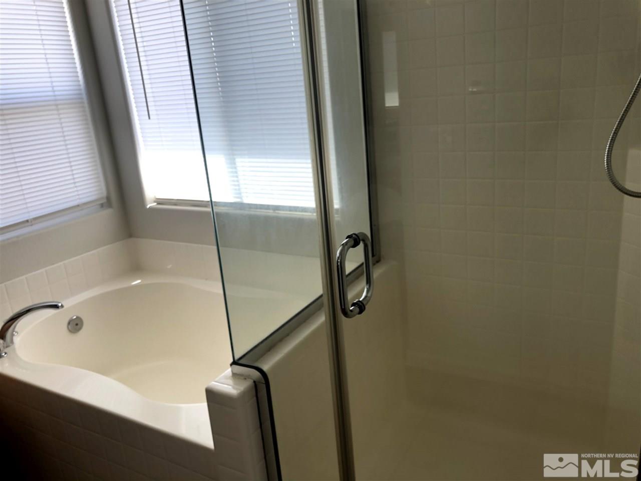 2288 Rio Lobo Lane Reno, NV 89521 - Photo 14 of 26 a bathroom with a tub and a window